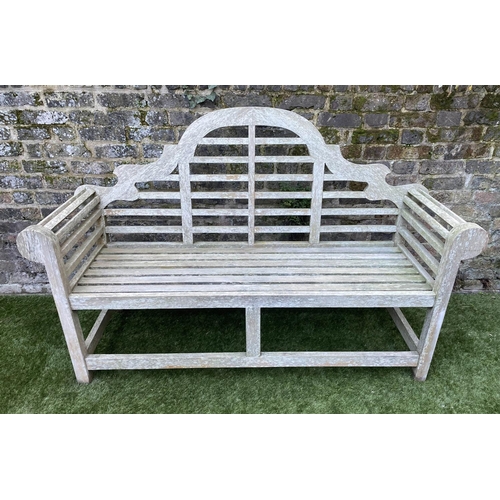 97 - LUTYENS STYLE GARDEN BENCH, weathered teak of slatted constructions after a design by Sir Edwin Luty... 