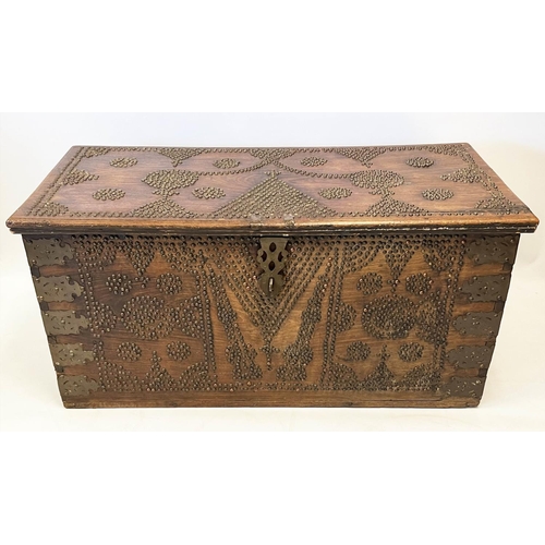 140 - ZANZIBAR TRUNK, 19th century hardwood and brass bound with rising lid, 57cm H x 116cm x 55cm.