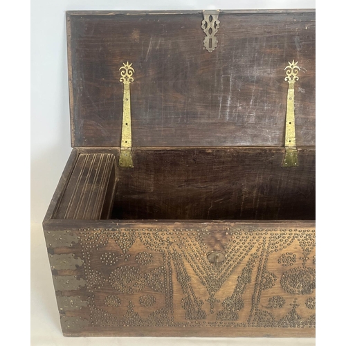 140 - ZANZIBAR TRUNK, 19th century hardwood and brass bound with rising lid, 57cm H x 116cm x 55cm.