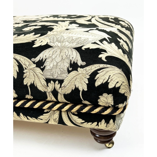 268 - FOOTSTOOL, upholstered in Versace style fabric with turned supports and castors, 112cm x 80cm x 41cm... 