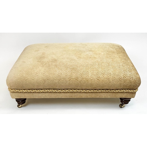 269 - FOOTSTOOL, upholstered in Versace style fabric with turned supports and castors, 112cm x 80cm x 41cm... 