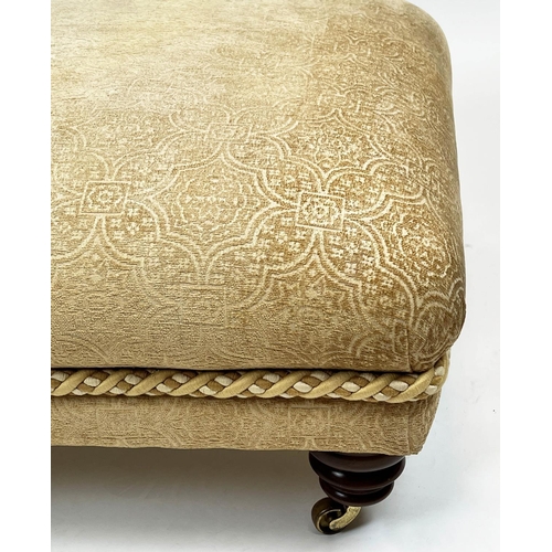 269 - FOOTSTOOL, upholstered in Versace style fabric with turned supports and castors, 112cm x 80cm x 41cm... 