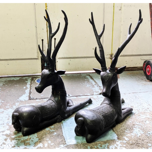 455 - RECUMBENT STAGS, a pair, perdu cast bronze, 80cm H.