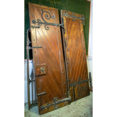 557 - DOORS, each 231cm H x 75cm excluding hinges, a pair, early 20th century stained pine and iron mounte... 