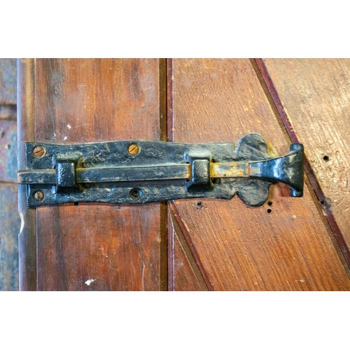 557 - DOORS, each 231cm H x 75cm excluding hinges, a pair, early 20th century stained pine and iron mounte... 