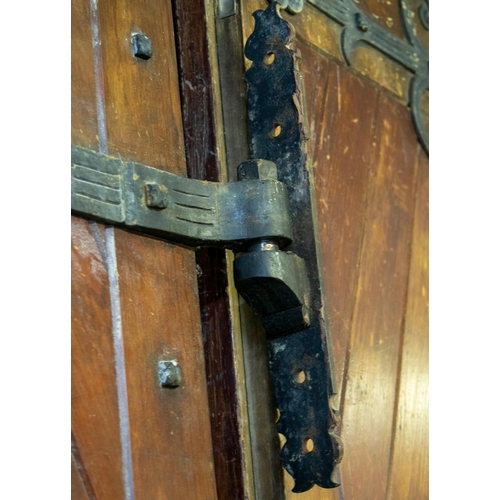 557 - DOORS, each 231cm H x 75cm excluding hinges, a pair, early 20th century stained pine and iron mounte... 