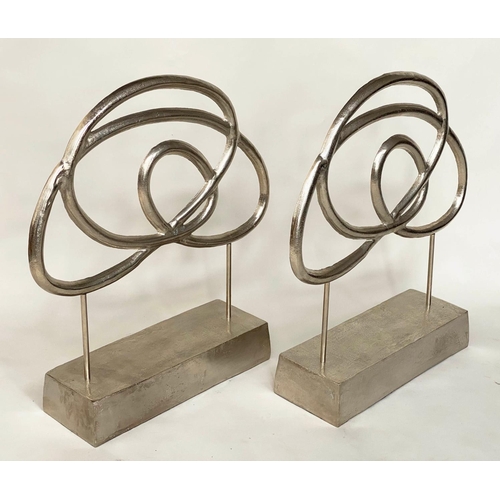 351 - SCULPTURES, a pair, silvered metal on stands, 76cm H x 70cm W. (2)