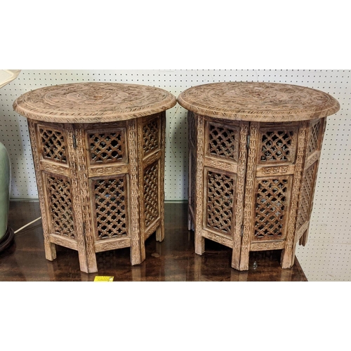 168 - ASIAN SIDE TABLES, a pair, each 47cm H x 46cm W, the circular carved wood tops on folding bases. (2)