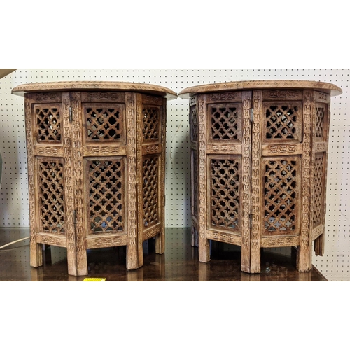 168 - ASIAN SIDE TABLES, a pair, each 47cm H x 46cm W, the circular carved wood tops on folding bases. (2)