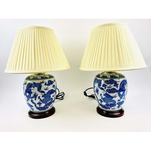 358 - TABLE LAMPS, a pair, 53cm H x 38cm diam., Chinese export style, blue and white, with shades, wooden ... 