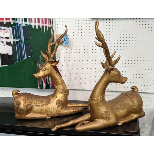 456 - RECUMBENT DEER, a pair, gilt metal, embossed decoration, 56cm H x 58cm L x 16cm D. (2)