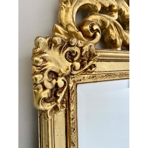 417 - WALL MIRROR, 125cm high, 67cm wide, Baroque style, gilt frame, bevelled edge glass, shell moulded fi... 