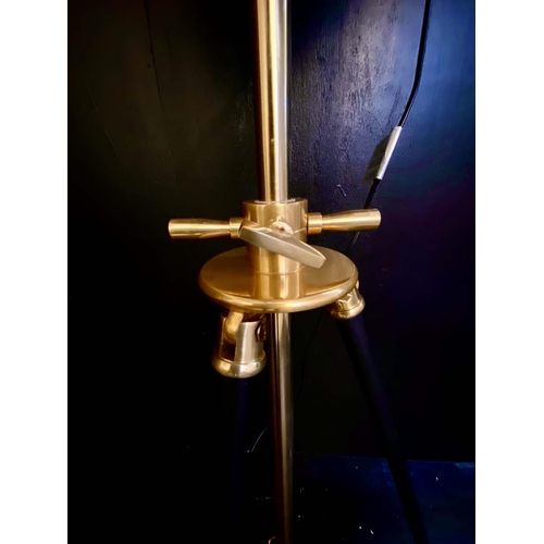 424 - TRIPOD STUDIO LAMP, 180cm high, 52cm diameter, gilt metal shade, adjustable height.