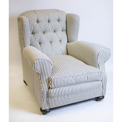 123 - WING ARMCHAIR, 95cm H x 95cm, early 20th century in new ticking upholstery on brass castors.