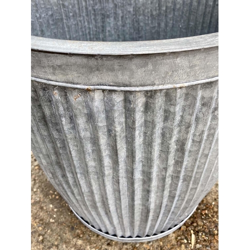 386 - GARDEN PLANTERS, a graduated set of three, largest 50cm high x 45cm diam., galvanised finish. (3)