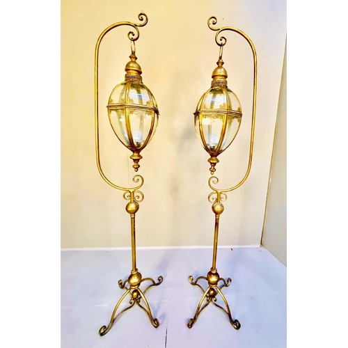 310 - STORM LANTERNS ON STANDS,  a pair, 163cm high, 35cm diameter, Regency style, gilt metal. (2)