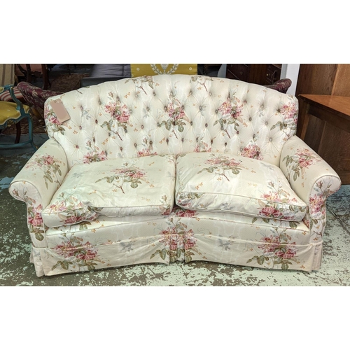 163 - KIDNEY SHAPED SOFA, 165cm W x 90cm H, in a floral fabric with matching pouffe, 36cm H x 59cm x 48cm.... 