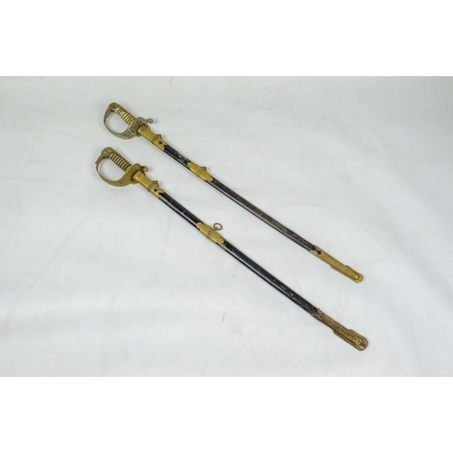 7 - THAI NAVY OFFICERS ELEPHANT HEAD DRESS SWORDS, two, in black leather scabbards with brass mounts. (2... 