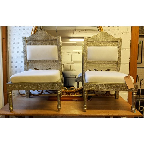 423 - INDIAN PIDHA CHAIRS, a pair, repoussé finish, white fabric cushions, 93cm H. (2)