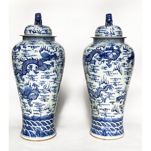 148 - DRAGON TEMPLE VASES, a pair, Chinese blue and white ceramic floor standing with lids, 105cm H. (2)