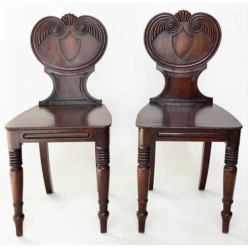 179 - HALL CHAIRS, a pair, Regency mahogany with shell scroll carved back and turned front supports, 39cm ... 