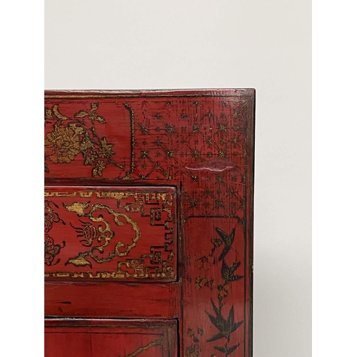 175 - CHINESE SIDE CABINET, scarlet lacquered with gilt Chinoiserie decoration, frieze drawer and two pane... 