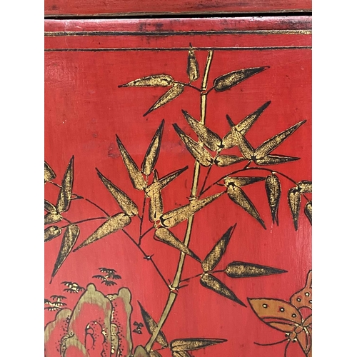 175 - CHINESE SIDE CABINET, scarlet lacquered with gilt Chinoiserie decoration, frieze drawer and two pane... 