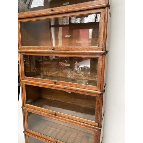 158 - GLOBE WERNICKE BOOKCASE, early 20th century oak comprising seven graduated glazed sections with corn... 