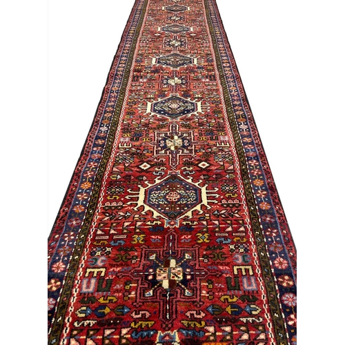 128 - PERSIAN HERIZ LONG RUNNER, 402cm x 82cm.