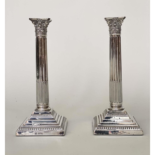 176 - SILVER CANDLESTICKS, a pair, Corinthian column, fluted and stop reeded by Barker Bros Chester 1924, ... 