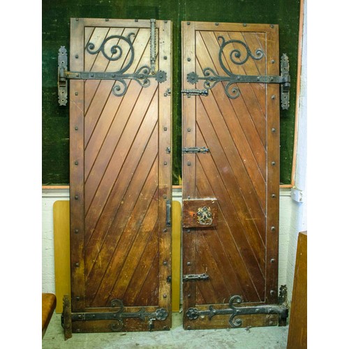 253 - DOORS, each 231cm H x 75cm excluding hinges, a pair, early 20th century stained pine and iron mounte... 