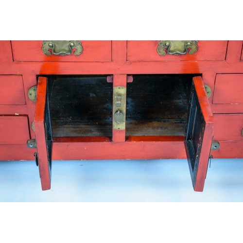 255 - CHINESE LACQUER CABINET, in rouge lacquer of eight drawers and a single central cabinet, 133cm x 60c... 