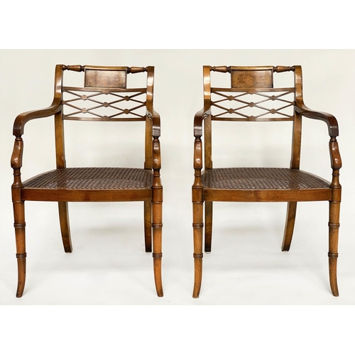 121 - ARMCHAIRS, a pair, Regency design walnut with tablet and lattice backs and cane seats (with cushions... 