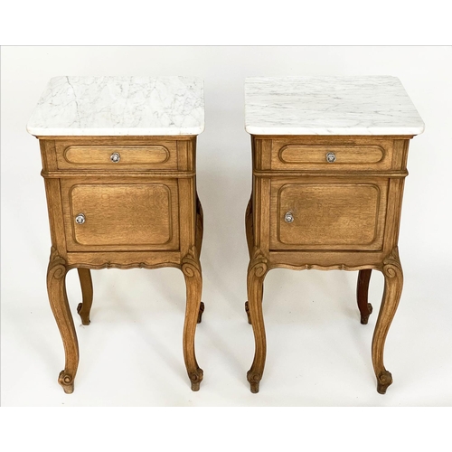 149 - BEDSIDE CABINETS, a pair, 19th century French oak each with drawer and panelled door and cabriole su... 