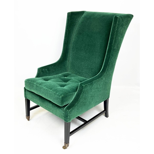 174 - WING ARMCHAIR, moss green mohair velvet upholstered with ebonised base and brass front castors, 105c... 