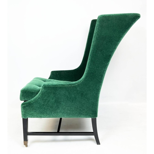 174 - WING ARMCHAIR, moss green mohair velvet upholstered with ebonised base and brass front castors, 105c... 