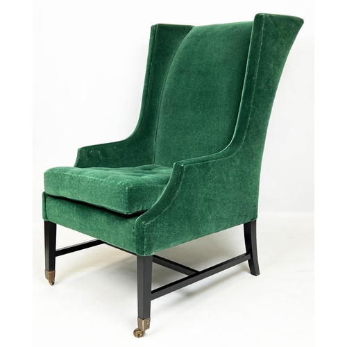 174 - WING ARMCHAIR, moss green mohair velvet upholstered with ebonised base and brass front castors, 105c... 