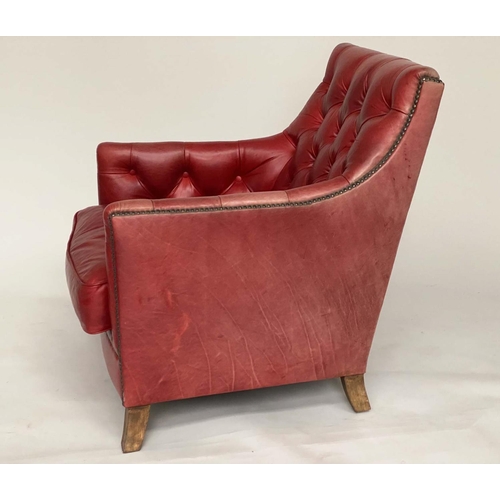 119 - ARMCHAIR AND STOOL, club style antique aged and brass studded scarlet leather upholstered with butto... 