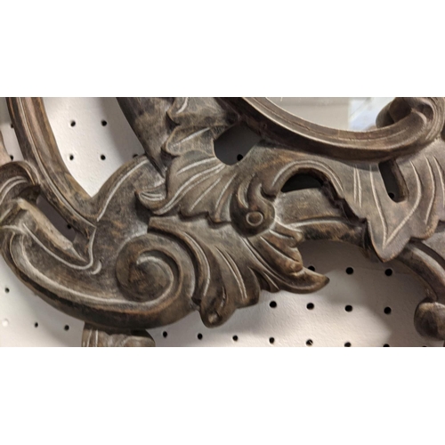 236 - WALL MIRRORS, a pair, Rococo style, ebonised wood finish with scrolled acanthus leaf frames, 117cm H... 