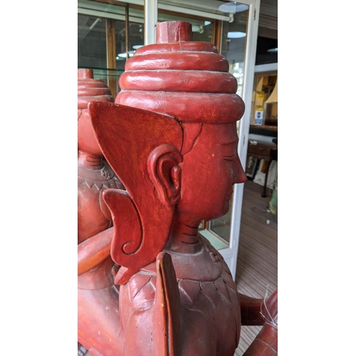 310 - THIA THEPPANOM COUPLE, carved wood, red lacquered finish, 128cm H. (2)