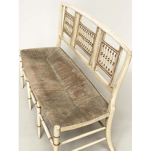 363 - HALL SEAT, 19th century Aesthetic cream and gilt heightened with rail back and rush seat, 117cm W.