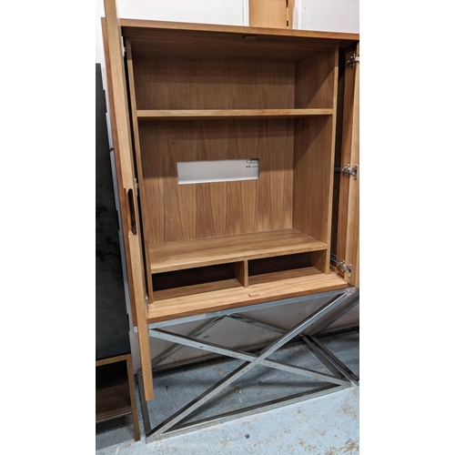 414 - MEDIA CABINET ON STAND, 115cm x 55cm x 182.5cm, metal work detail to doors which tuck away revealing... 