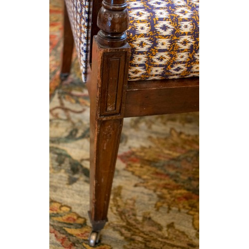 228 - BERGERE, 90cm H x 59cm W, Edwardian mahogany in patterned blue upholstery on brass castors