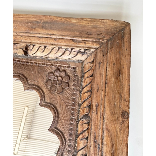 204 - WALL MIRROR, 19th century Indian teak with carved arched frame, 80cm x 120cm H.