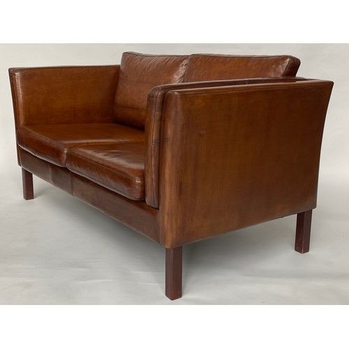 298 - 1970's Danish two seater grained tanned leather and teak supports. 147 cm W.