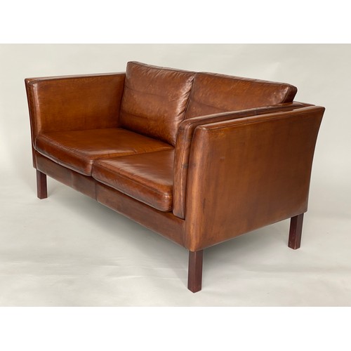 298 - 1970's Danish two seater grained tanned leather and teak supports. 147 cm W.