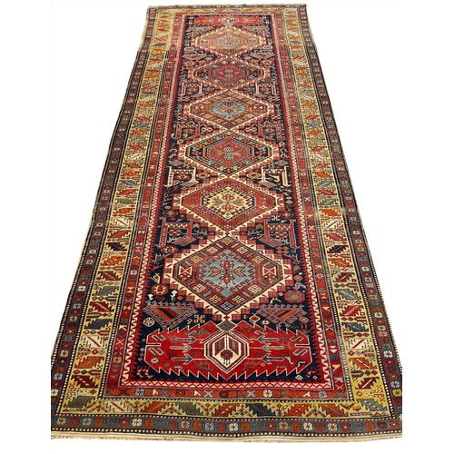 125 - ANTIQUE CAUCASIAN CORRIDOR CARPET, 332cm x 138cm.