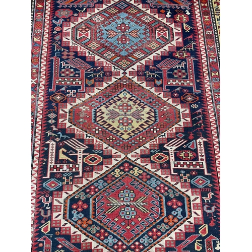 125 - ANTIQUE CAUCASIAN CORRIDOR CARPET, 332cm x 138cm.