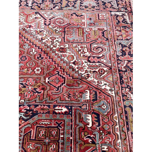 129 - PERSIAN HERIZ CARPET, 405cm x 300cm.