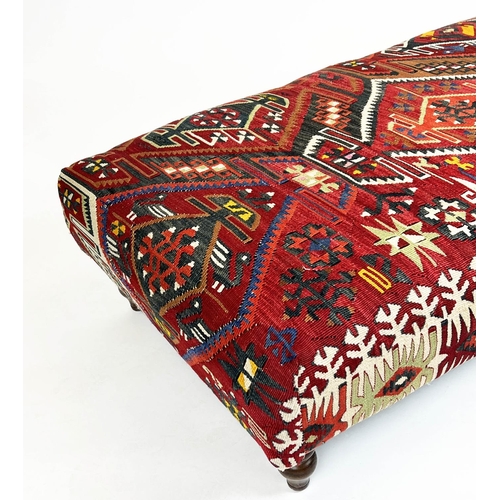 221 - KILIM FOOTSTOOL, Anatolian kilim upholstered with turned supports, 35cm H x 137cm x 69cm.